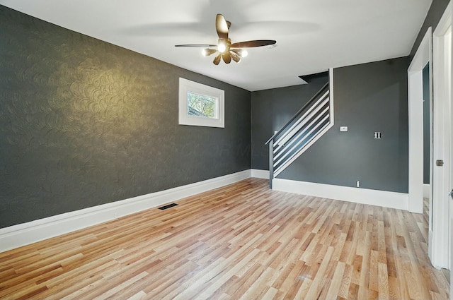 219 Belvidere Ave, Columbus, OH 43223 - empty room with baseboards, a ceiling fan, wood finished floors, and stairway
