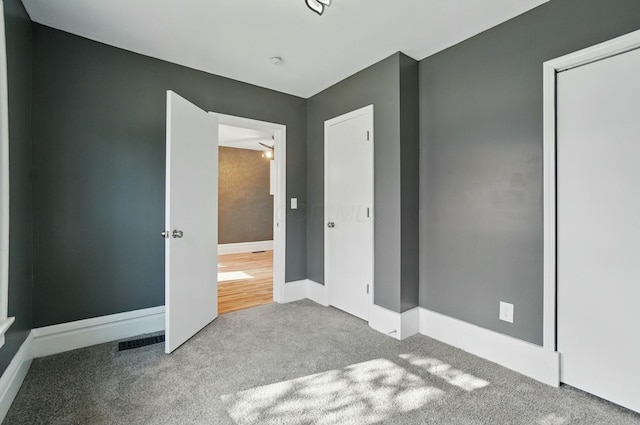 219 Belvidere Ave, Columbus, OH 43223 - unfurnished bedroom with baseboards, visible vents, and carpet floors