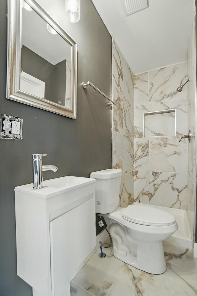 219 Belvidere Ave, Columbus, OH 43223 - bathroom featuring marble finish floor, visible vents, toilet, vanity, and a marble finish shower