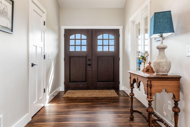 foyer entrance with baseboards and dark wood finished floors