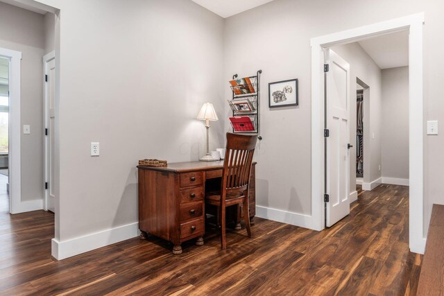 home office with baseboards and dark wood-style flooring