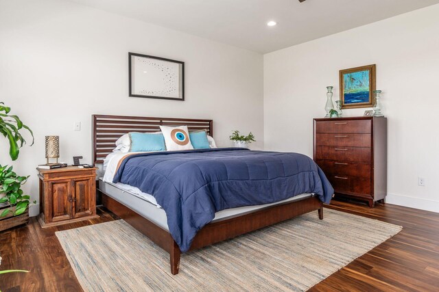 bedroom with baseboards, wood finished floors, and recessed lighting