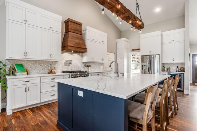 kitchen featuring a sink, premium range hood, backsplash, appliances with stainless steel finishes, and wine cooler