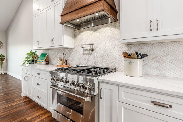 kitchen featuring white cabinets, decorative backsplash, custom exhaust hood, and stainless steel range