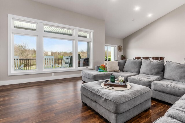 living area with lofted ceiling and dark wood finished floors
