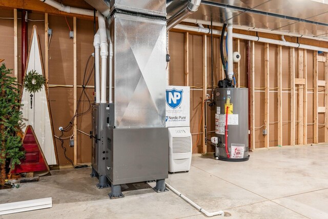 utility room with water heater and heating unit
