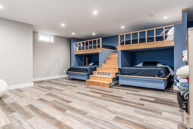 living room with baseboards, wood finished floors, and recessed lighting