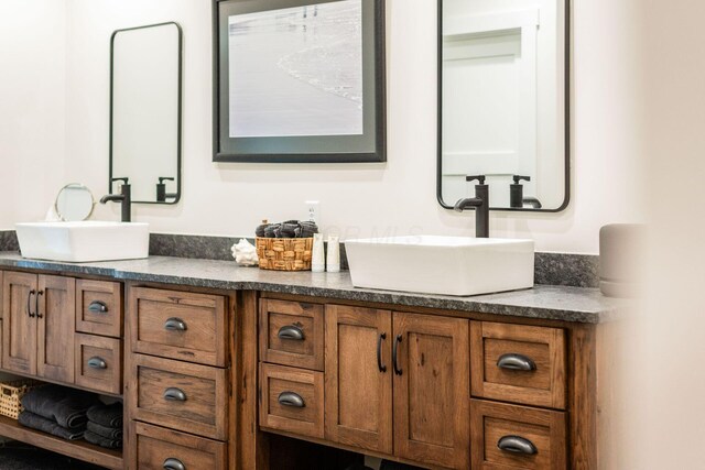 full bath featuring double vanity and a sink
