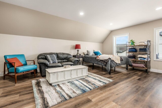bedroom with lofted ceiling, wood finished floors, and recessed lighting