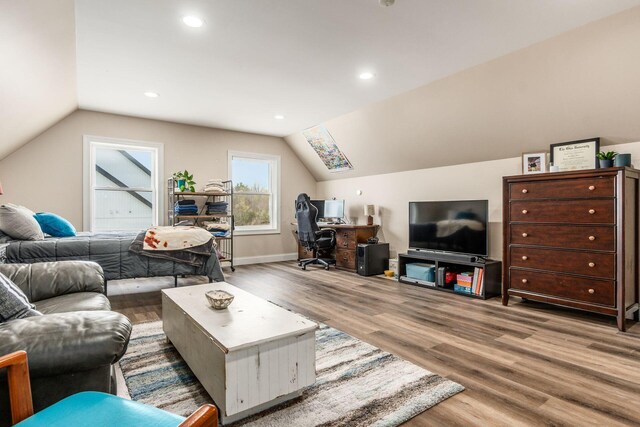 living room featuring baseboards, lofted ceiling, wood finished floors, and recessed lighting