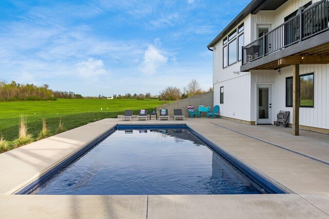 pool featuring a yard and a patio