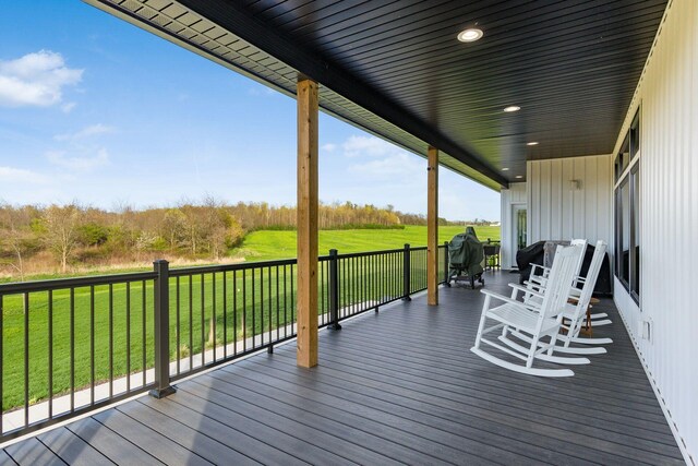 wooden deck featuring a yard