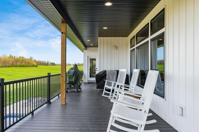 wooden deck featuring a yard and area for grilling