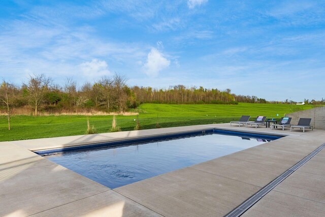 pool featuring a lawn and a patio