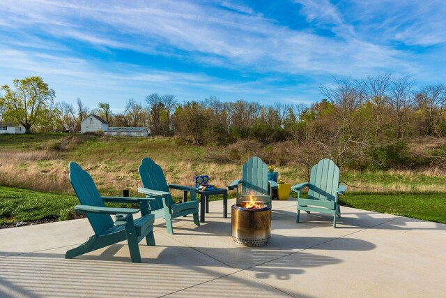 view of patio / terrace featuring an outdoor fire pit