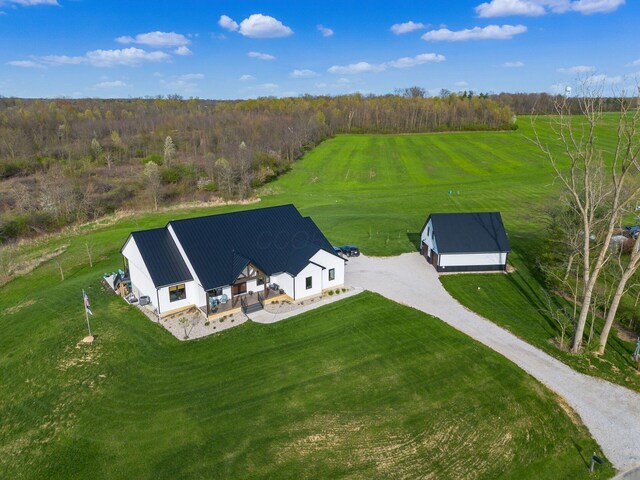 drone / aerial view featuring a rural view and a view of trees