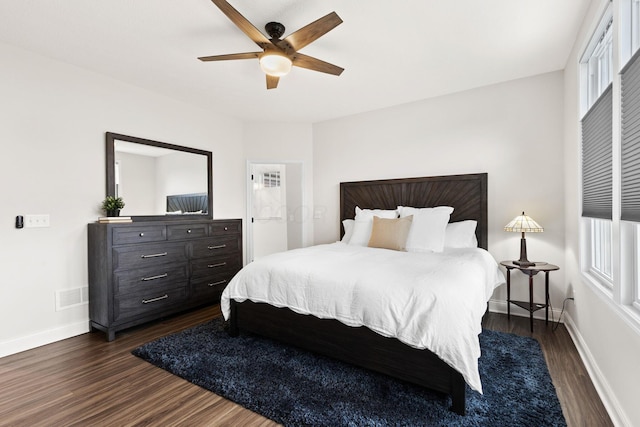 bedroom with a ceiling fan, baseboards, visible vents, and dark wood-type flooring
