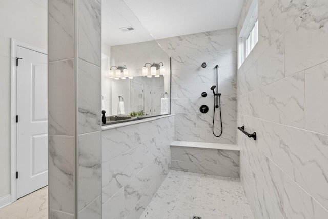 full bathroom with a marble finish shower, visible vents, and marble finish floor