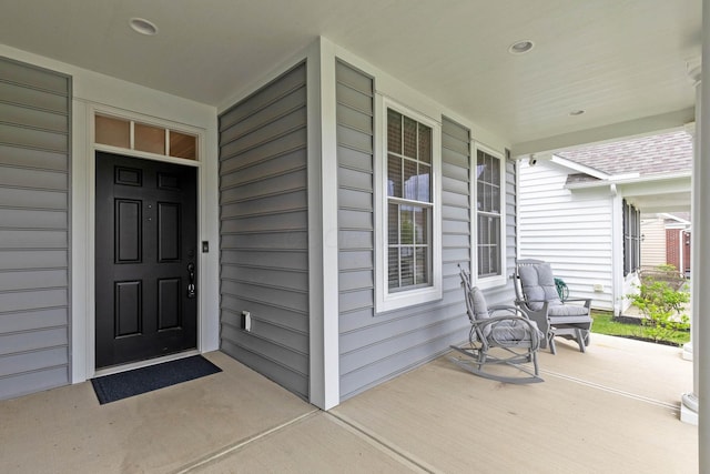 view of exterior entry with a porch