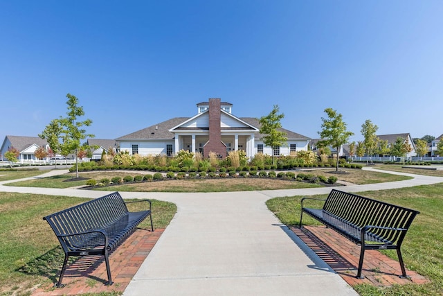 view of property's community with a lawn