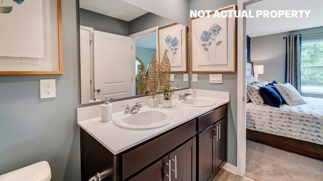 6357 Darby Plains St, Columbus, OH 43228 - full bathroom with double vanity, ensuite bathroom, a sink, and toilet