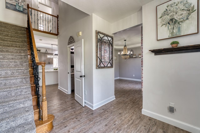779 Millstone Ln, Mount Vernon, OH 43050 - entryway featuring baseboards, wood finished floors, stairs, and an inviting chandelier