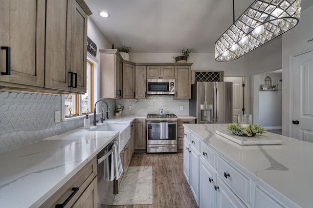 779 Millstone Ln, Mount Vernon, OH 43050 - kitchen featuring light wood-type flooring, decorative backsplash, a sink, and appliances with stainless steel finishes
