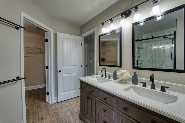 779 Millstone Ln, Mount Vernon, OH 43050 - full bath with a walk in closet, wood finished floors, a marble finish shower, and a sink