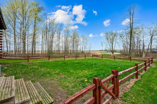 view of yard featuring fence and a rural view