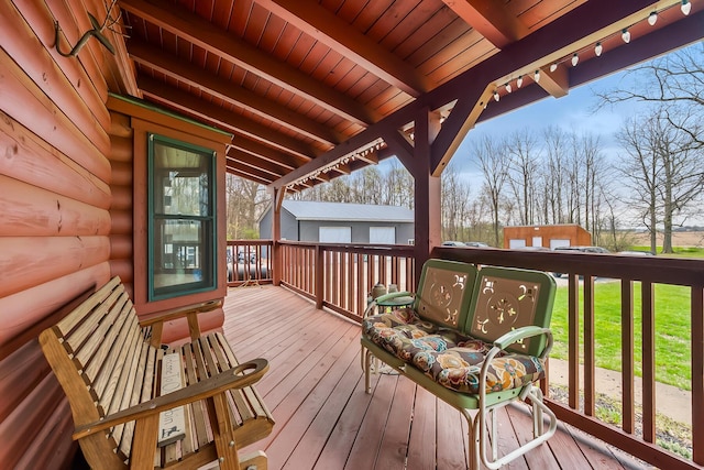wooden terrace with a yard and an outbuilding