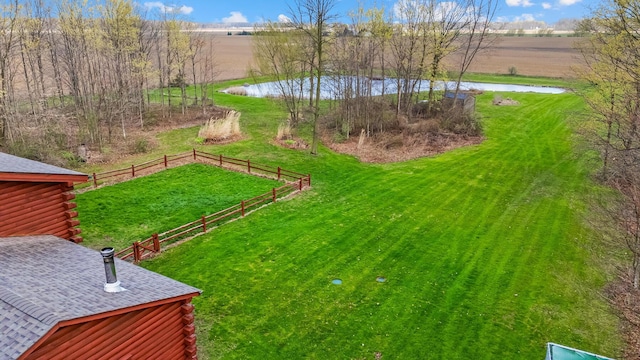 view of yard featuring a water view and fence