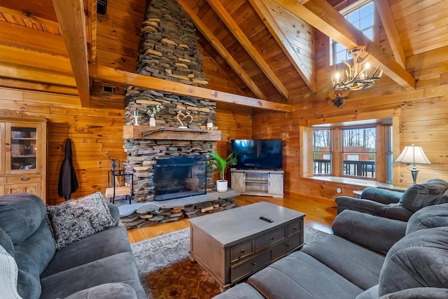 living area featuring wood finished floors, wood walls, wooden ceiling, and a notable chandelier