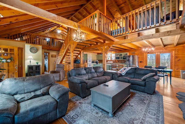 living area featuring vaulted ceiling with beams, wood ceiling, wood-type flooring, wood walls, and a notable chandelier