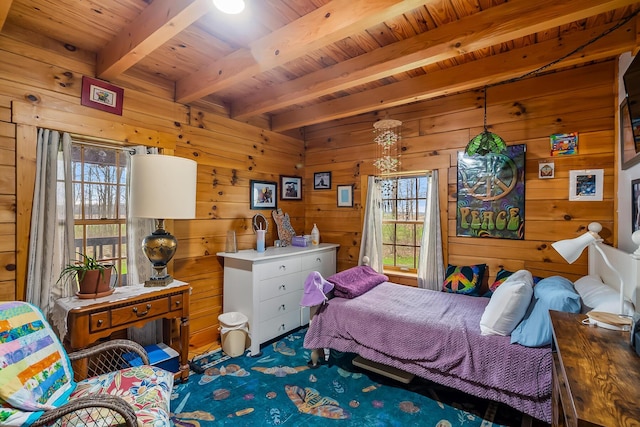 bedroom with beamed ceiling, wooden ceiling, wooden walls, and carpet