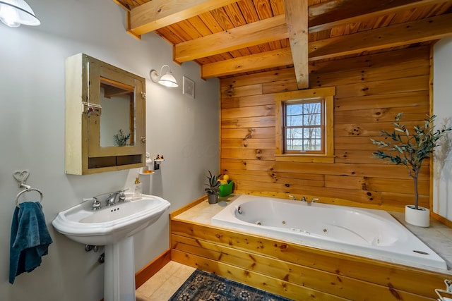 full bath with wooden walls, a whirlpool tub, wooden ceiling, tile patterned flooring, and beam ceiling