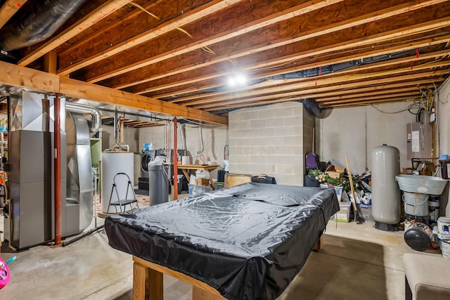 playroom featuring concrete floors, gas water heater, billiards, and heating unit