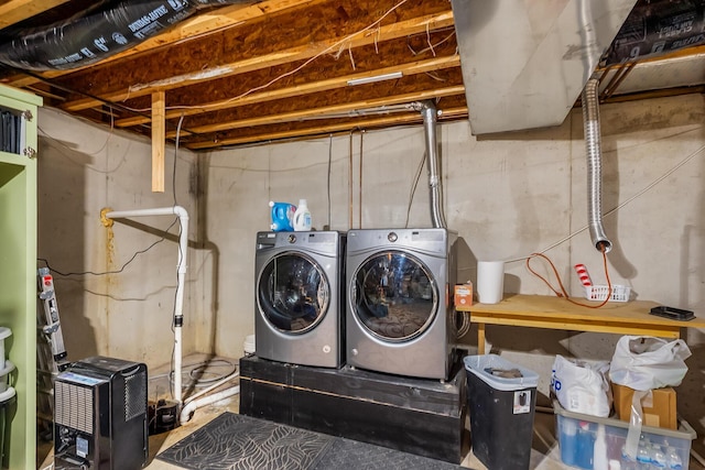 clothes washing area featuring washing machine and dryer and laundry area