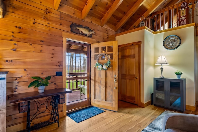 entryway featuring baseboards, hardwood / wood-style floors, beam ceiling, and wooden ceiling