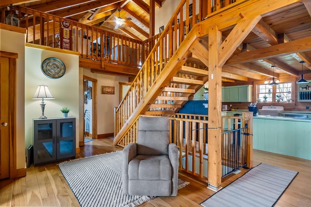 living room featuring wooden ceiling, baseboards, hardwood / wood-style floors, and vaulted ceiling with beams