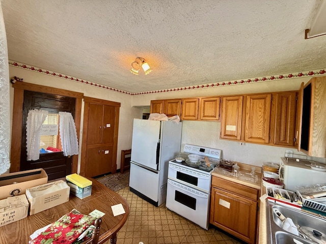15825 State Route 207, Mount Sterling, OH 43143 - kitchen with brown cabinetry, white appliances, light floors, light countertops, and a textured ceiling