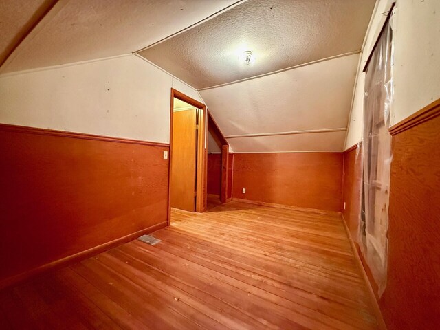 15825 State Route 207, Mount Sterling, OH 43143 - bonus room featuring wood-type flooring, lofted ceiling, and a textured ceiling