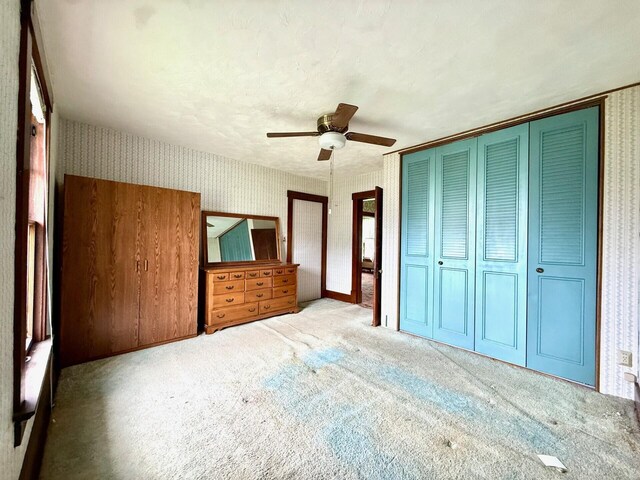 15825 State Route 207, Mount Sterling, OH 43143 - unfurnished bedroom featuring wallpapered walls, carpet flooring, a closet, and a ceiling fan