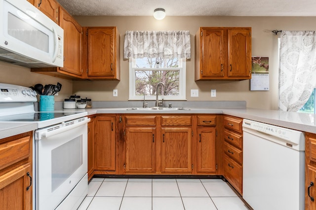 934 Carron Ct, Pickerington, OH 43147 - kitchen with light countertops, a sink, brown cabinets, and white appliances