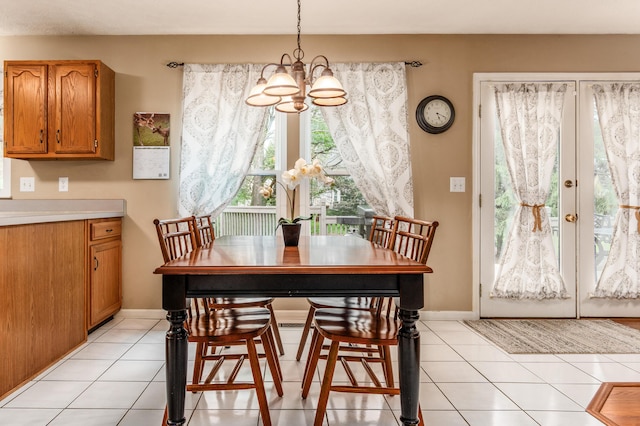 934 Carron Ct, Pickerington, OH 43147 - dining room with light tile patterned floors, an inviting chandelier, french doors, and baseboards