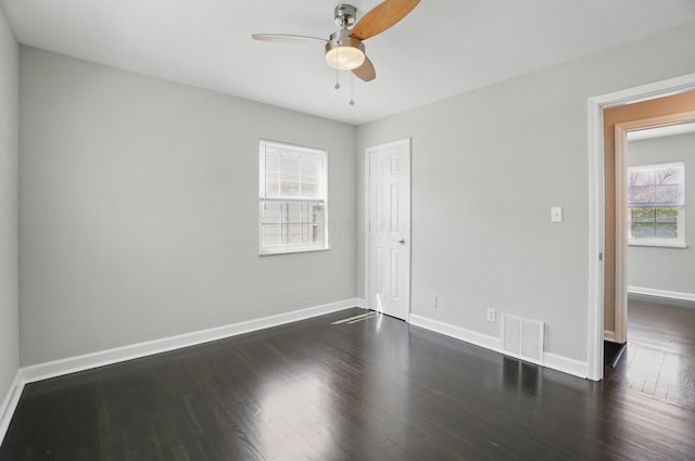 interior space with dark wood finished floors, visible vents, a closet, baseboards, and ceiling fan