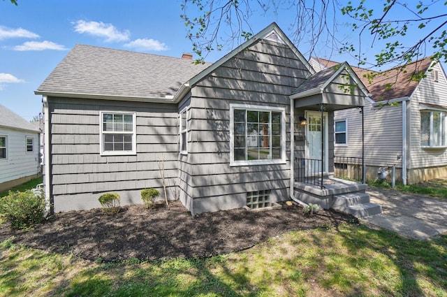 bungalow-style house with a shingled roof