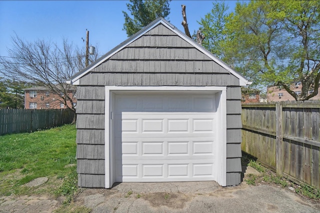 detached garage featuring fence