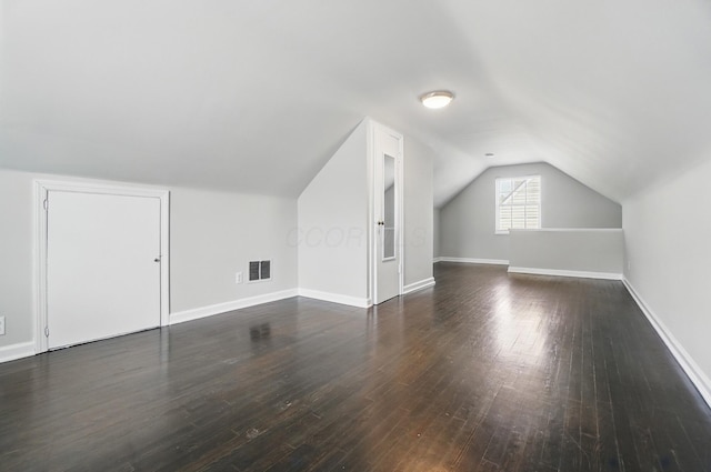 bonus room featuring vaulted ceiling, wood finished floors, visible vents, and baseboards