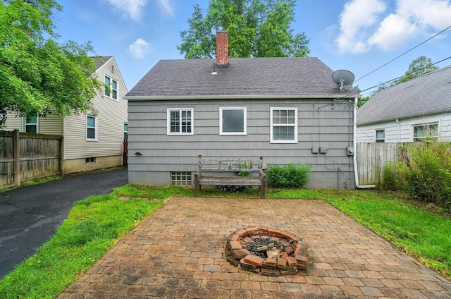 62 Rosslyn Ave, Columbus, OH 43214 - back of house featuring a chimney, a fire pit, a patio, and roof with shingles