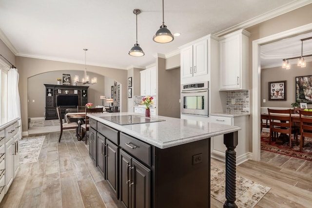 6509 Spring Run Dr, Westerville, OH 43082 - kitchen with crown molding, white cabinets, and stainless steel oven